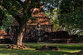 Thailand, Old Sukhothai - Wat Mahathat, square-based, multi-layered chedi with statues of seated Buddha at each side.
